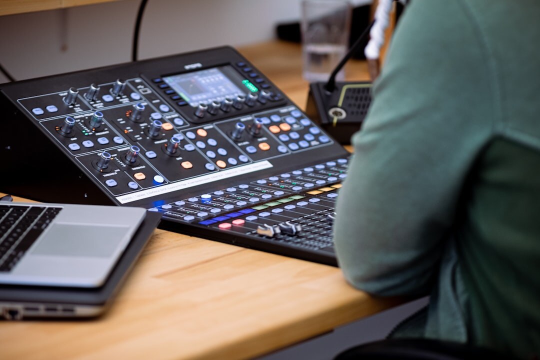 Finnish technician reviewing studio equipment plans on a laptop